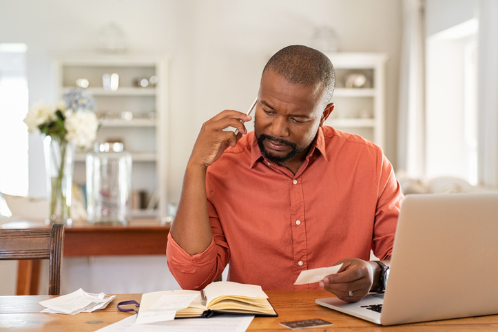 man at desk reviewing debt