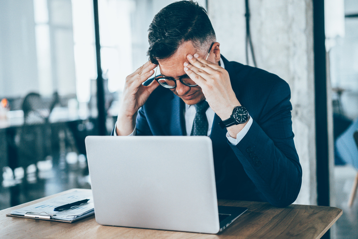 man at desk stressed about retirement